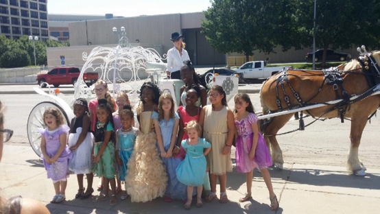 A group of children posing for a picture in front of a fountain.