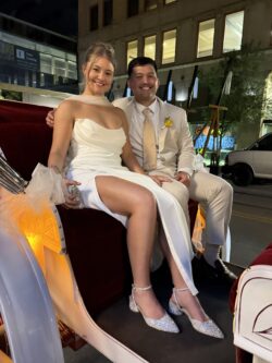Couple in formal attire on carriage ride.